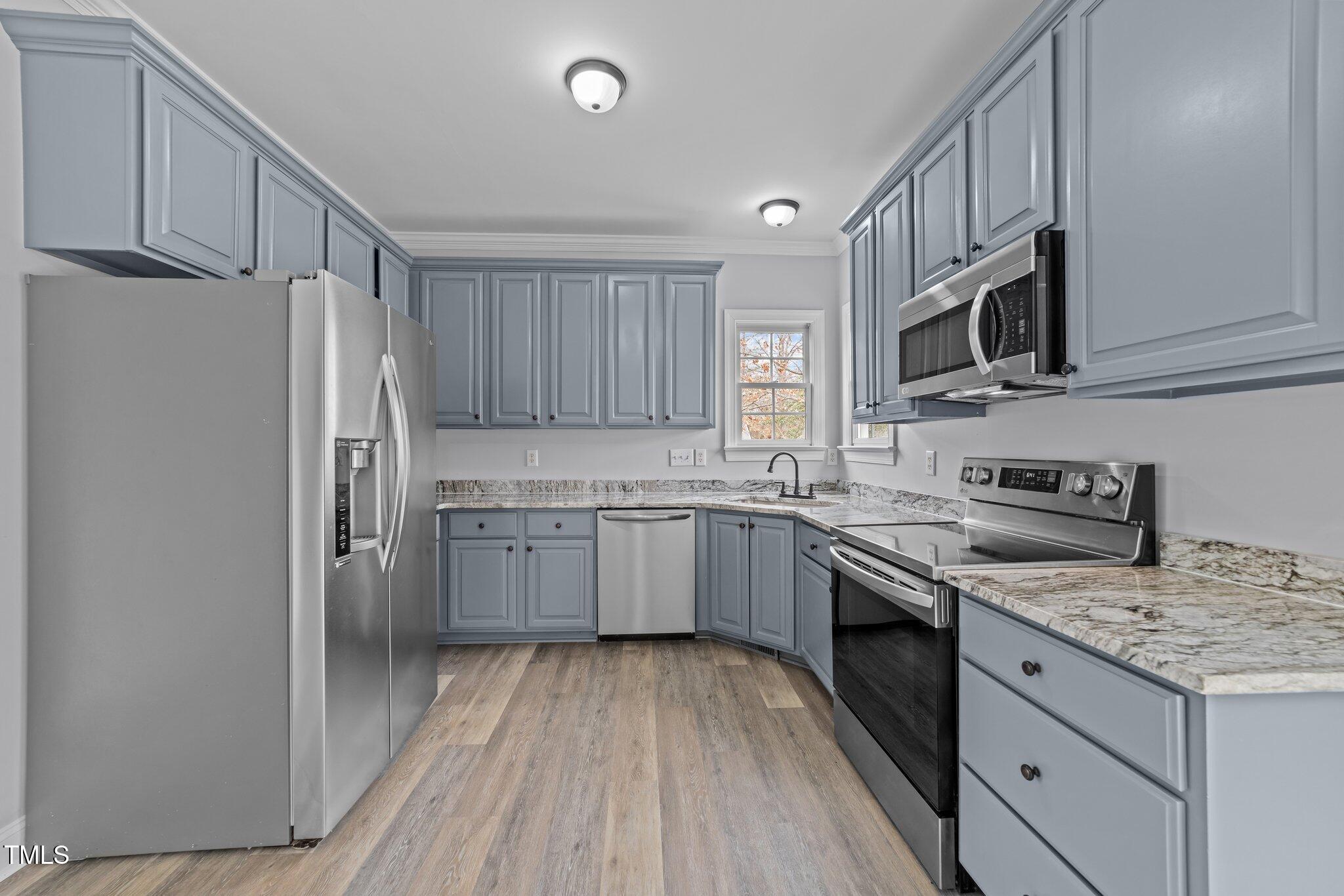 3525 La Costa Way Raleigh, NC 27610 - Photo 12 of 45 a kitchen with granite countertop a sink stove and refrigerator