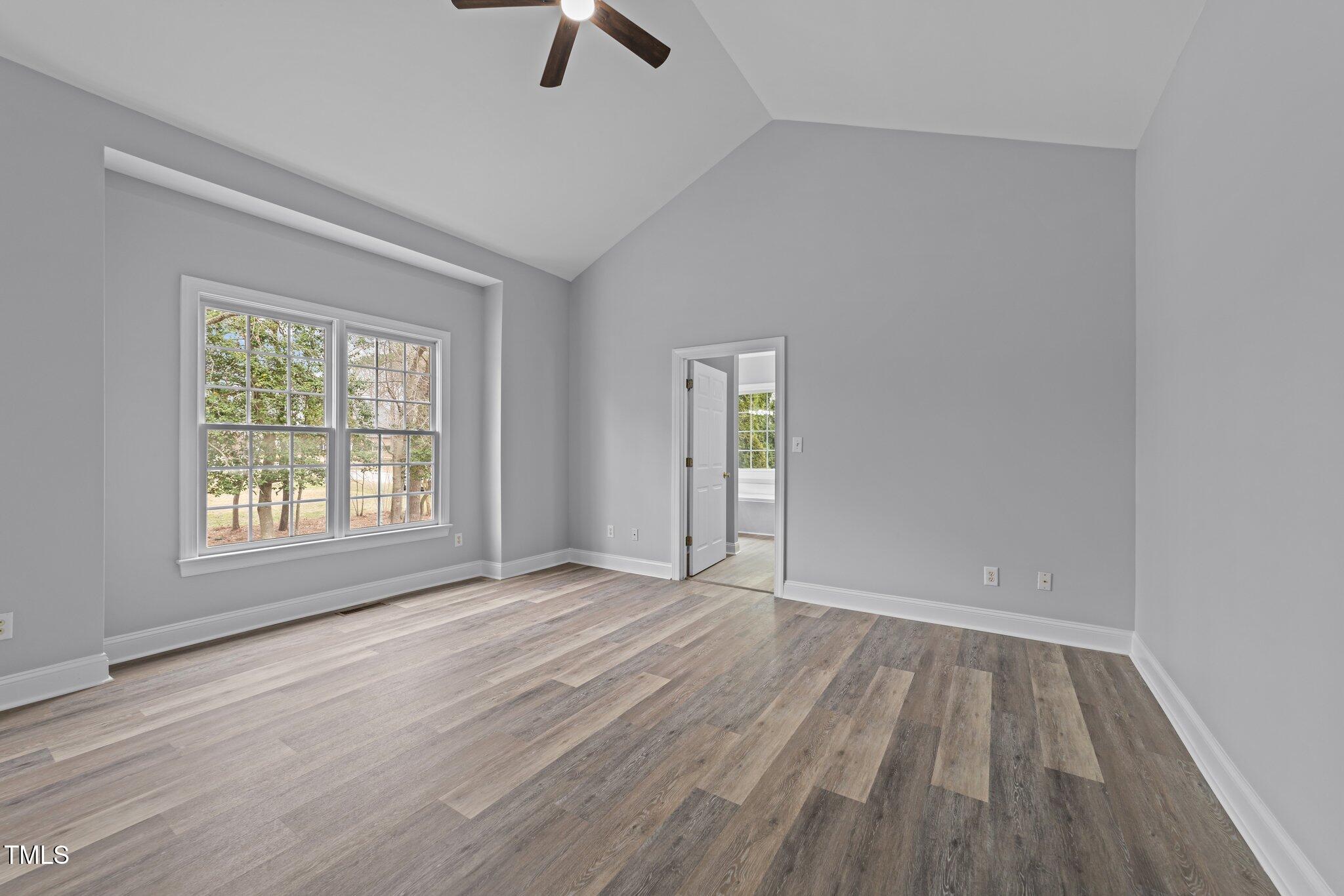 3525 La Costa Way Raleigh, NC 27610 - Photo 15 of 45 an empty room with window and wooden floor