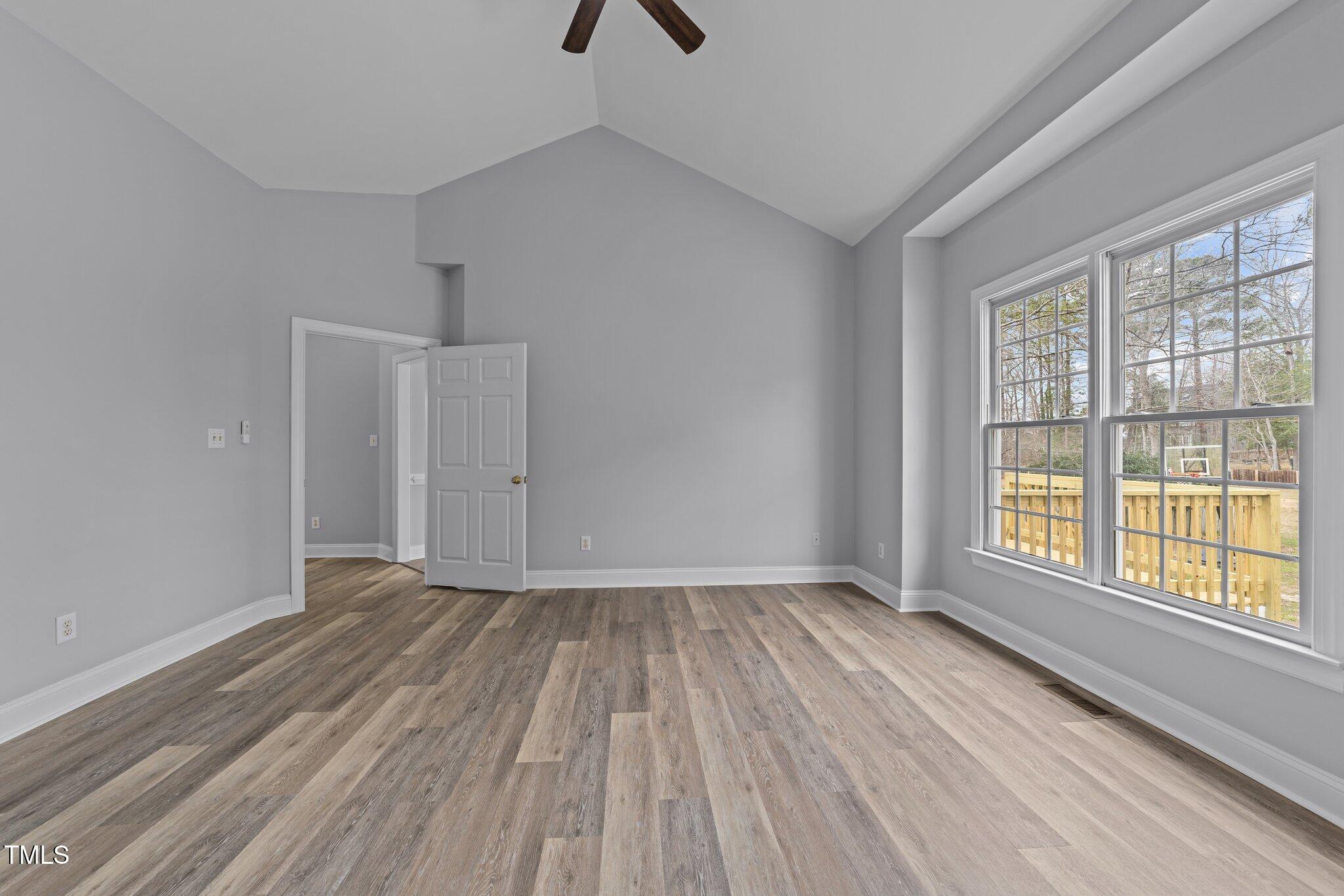 3525 La Costa Way Raleigh, NC 27610 - Photo 16 of 45 a view of an empty room with wooden floor and a window