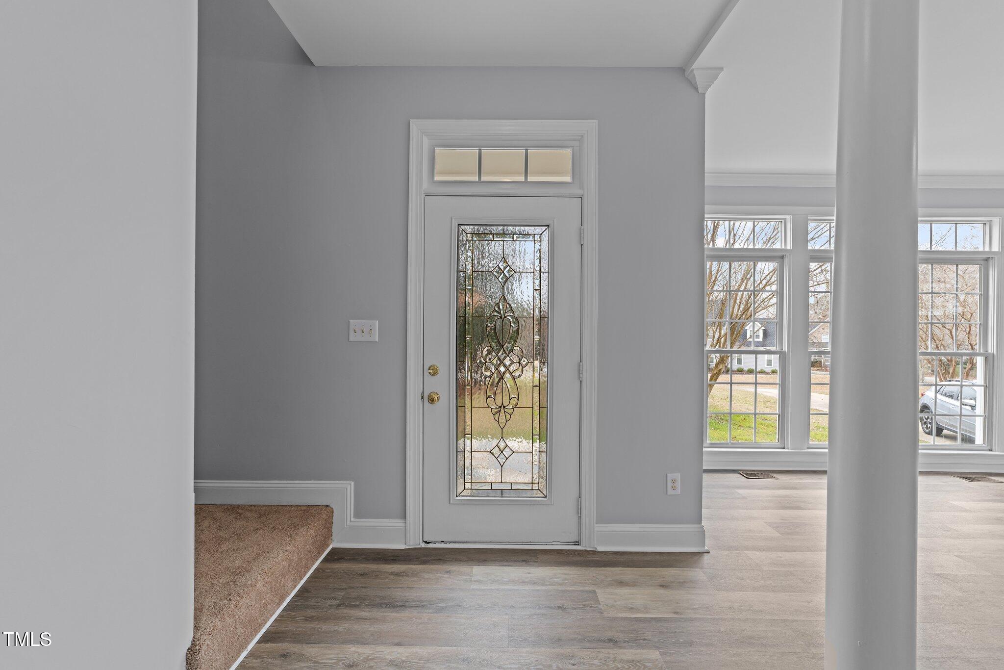 3525 La Costa Way Raleigh, NC 27610 - Photo 4 of 45 a view of an empty room with wooden floor and a window