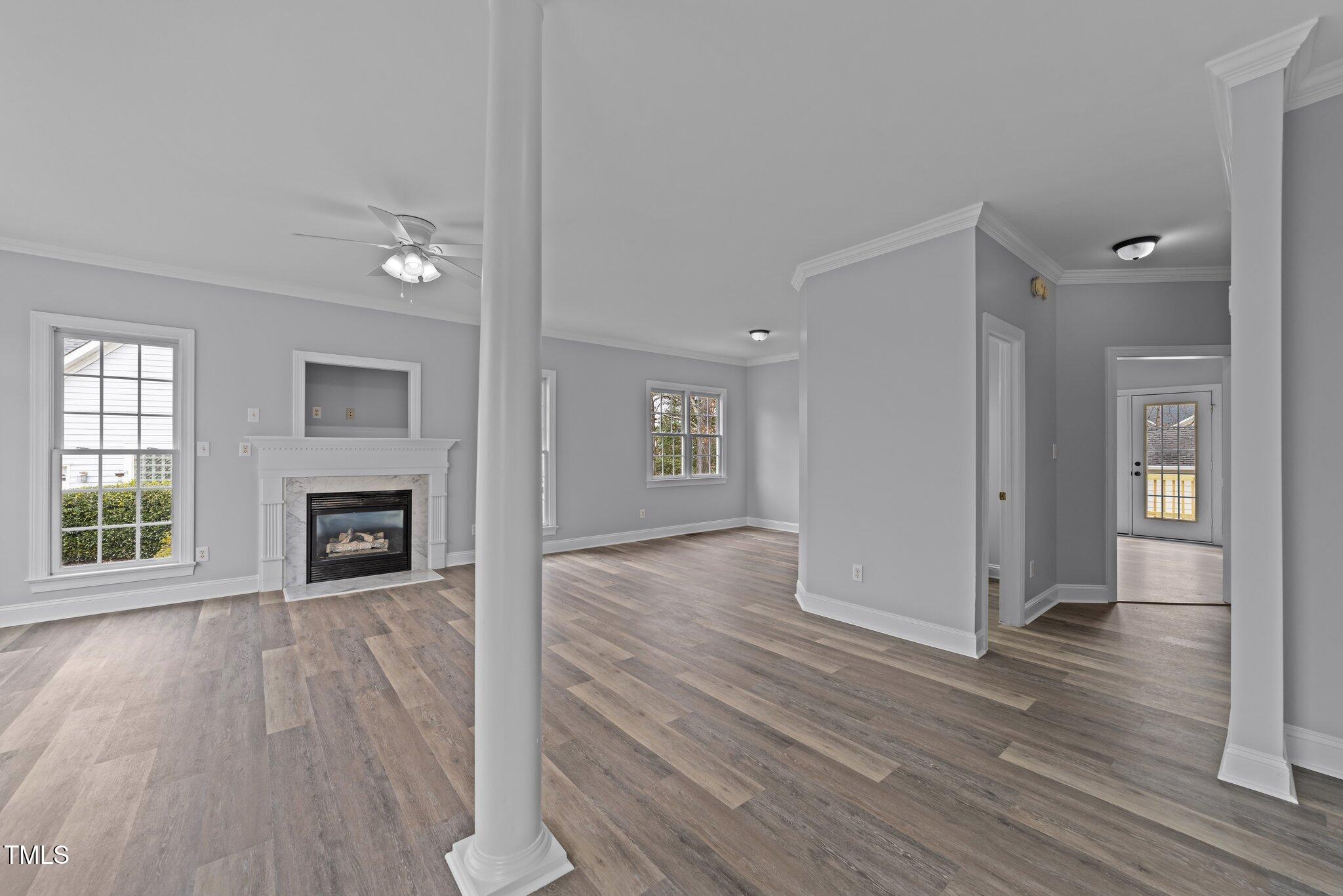 3525 La Costa Way Raleigh, NC 27610 - Photo 5 of 45 an empty room with wooden floor fireplace and windows