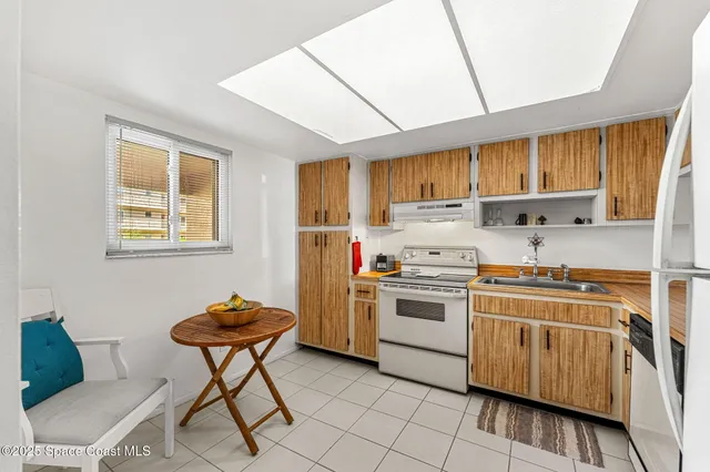 a kitchen with a stove a sink and a microwave