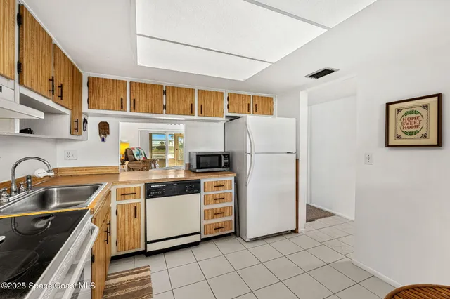 a kitchen with a sink cabinets and stainless steel appliances