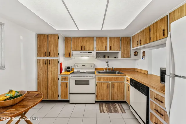 a kitchen with a stove sink and a refrigerator