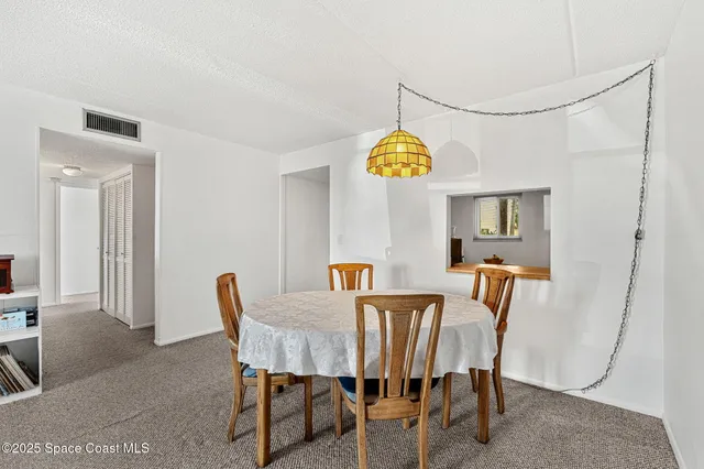 a view of a dining room and chandelier