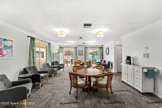 a dining room with furniture and window