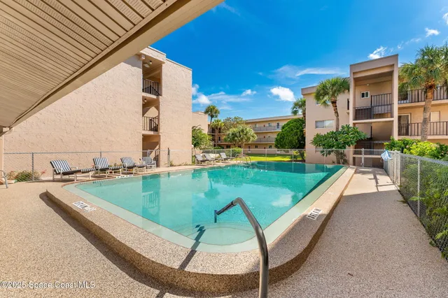 a view of a swimming pool with a patio