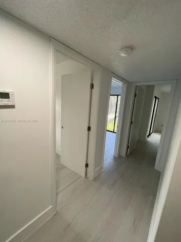 an empty room with mirror and stairs