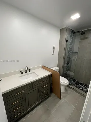 a spacious bathroom with a double vanity sink toilet and shower