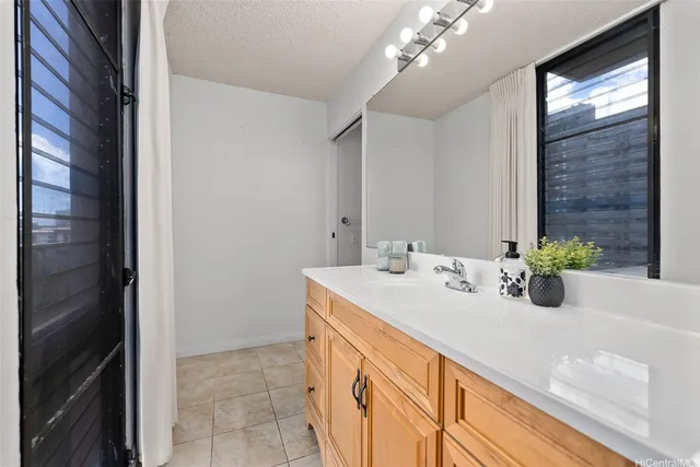 a bathroom with a sink a vanity and a mirror