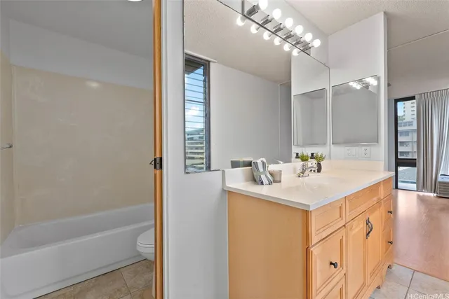 a bathroom with a sink a mirror and a bathtub