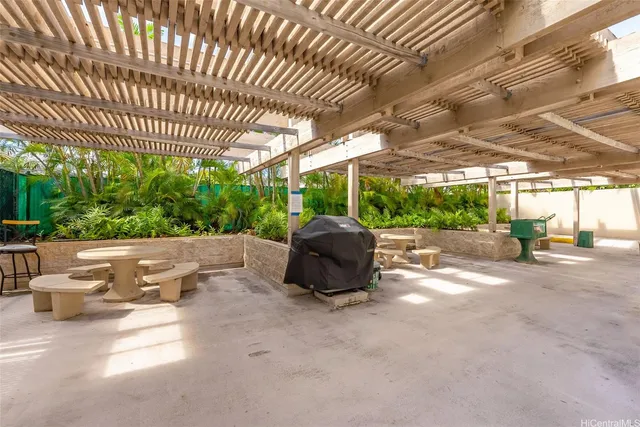 a view of a patio with table and chairs and potted plants