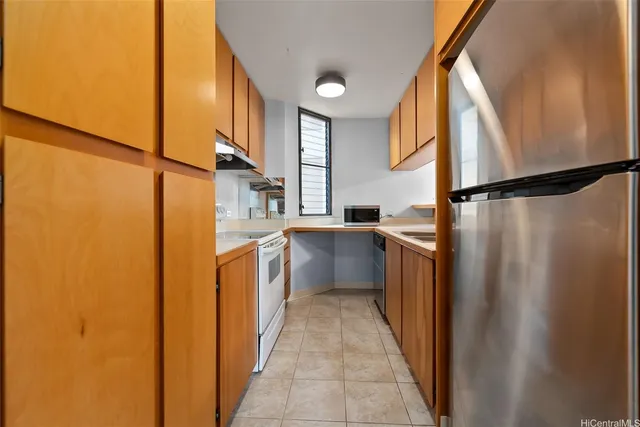 a kitchen with a refrigerator and a stove