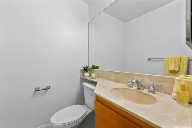 a bathroom with a sink toilet and a mirror