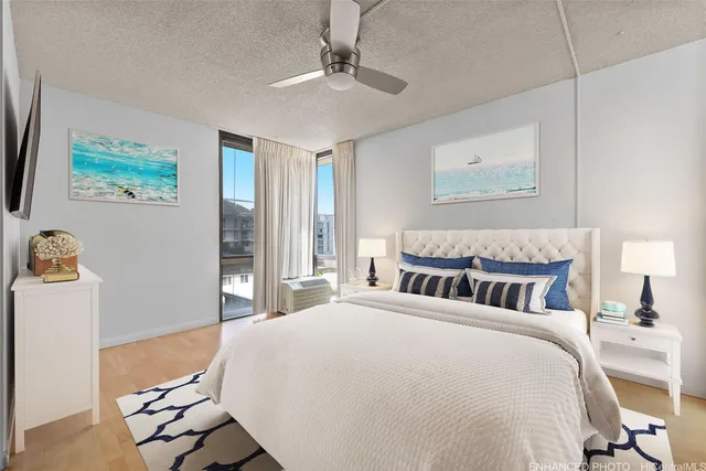 a spacious bedroom with a bed and a chandelier