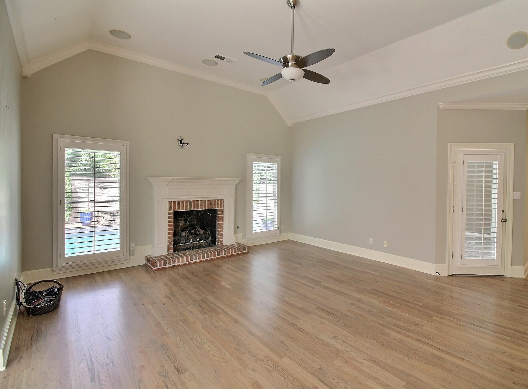 595 Kenrose Street Collierville, TN 38017 - Photo 14 of 38 an empty room with windows a fireplace a sink and wooden floor