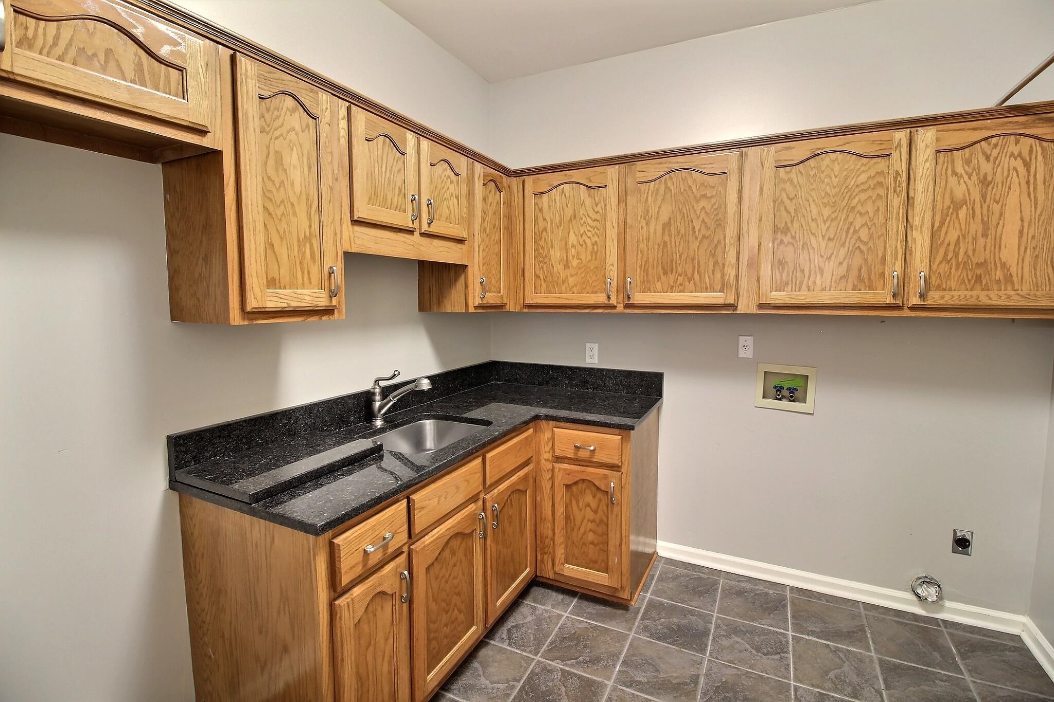 595 Kenrose Street Collierville, TN 38017 - Photo 15 of 38 a kitchen with stainless steel appliances granite countertop a sink stove and cabinets