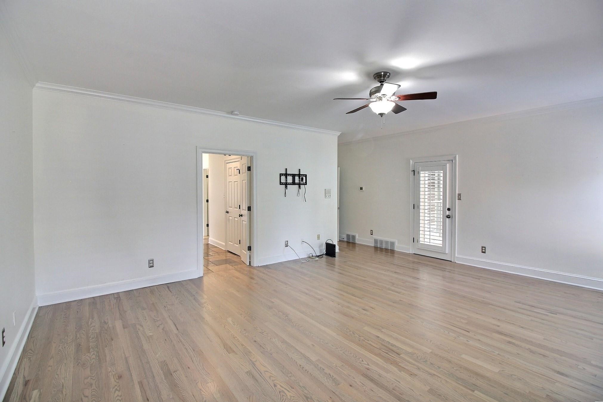 595 Kenrose Street Collierville, TN 38017 - Photo 18 of 38 a view of empty room with wooden floor and ceiling fan