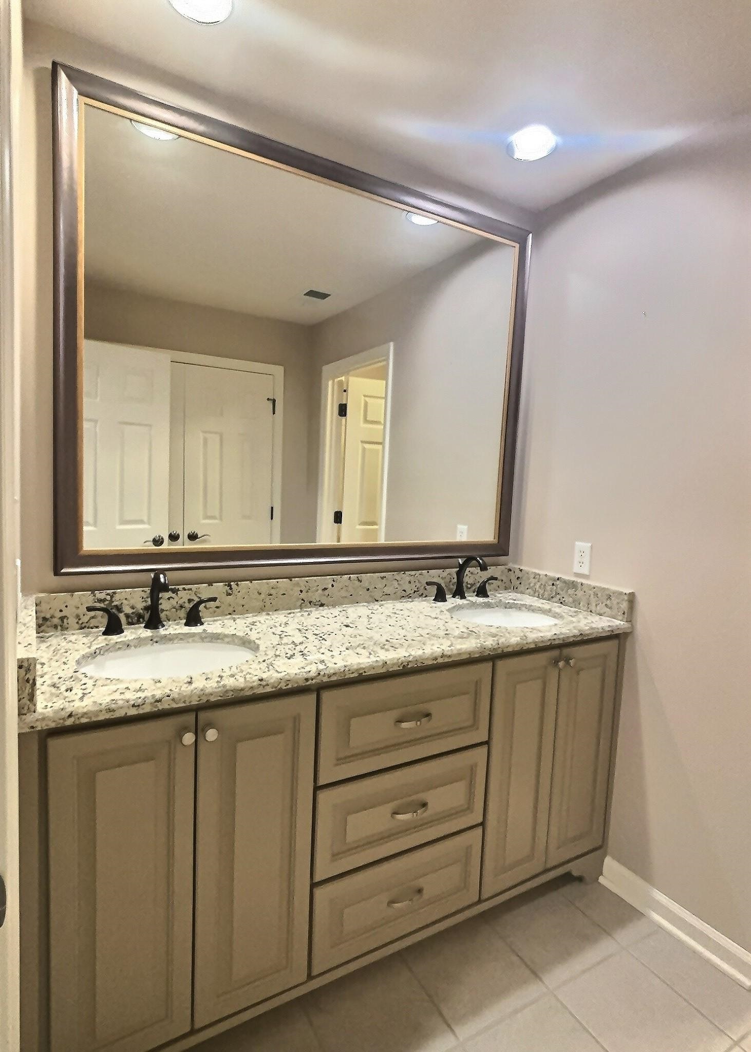 595 Kenrose Street Collierville, TN 38017 - Photo 27 of 38 a bathroom with a granite countertop sink and a mirror