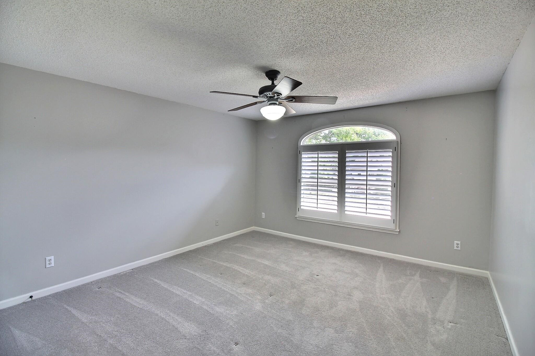 595 Kenrose Street Collierville, TN 38017 - Photo 28 of 38 an empty room with chandelier fan and windows