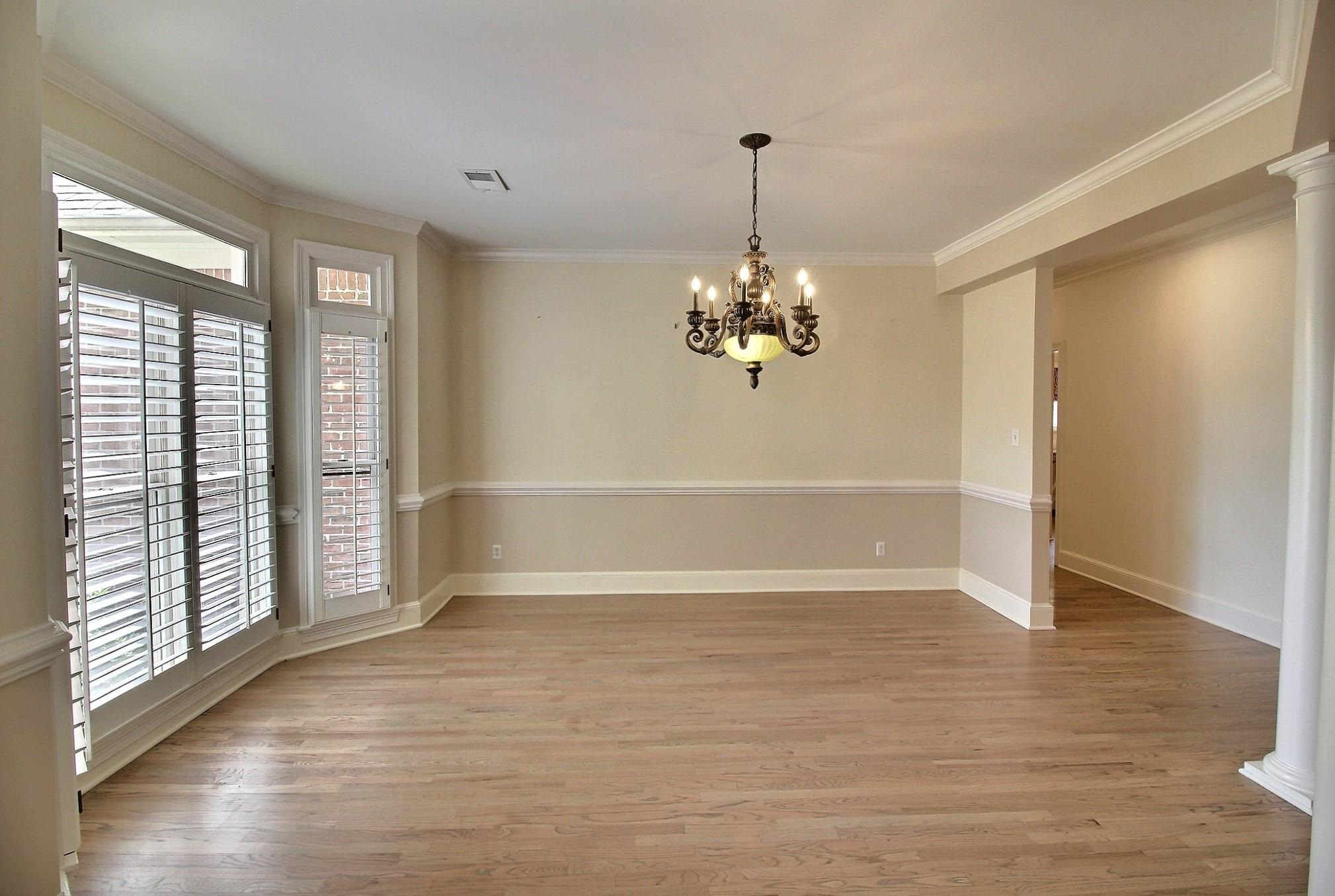 595 Kenrose Street Collierville, TN 38017 - Photo 5 of 38 a view of an empty room with wooden floor and a window