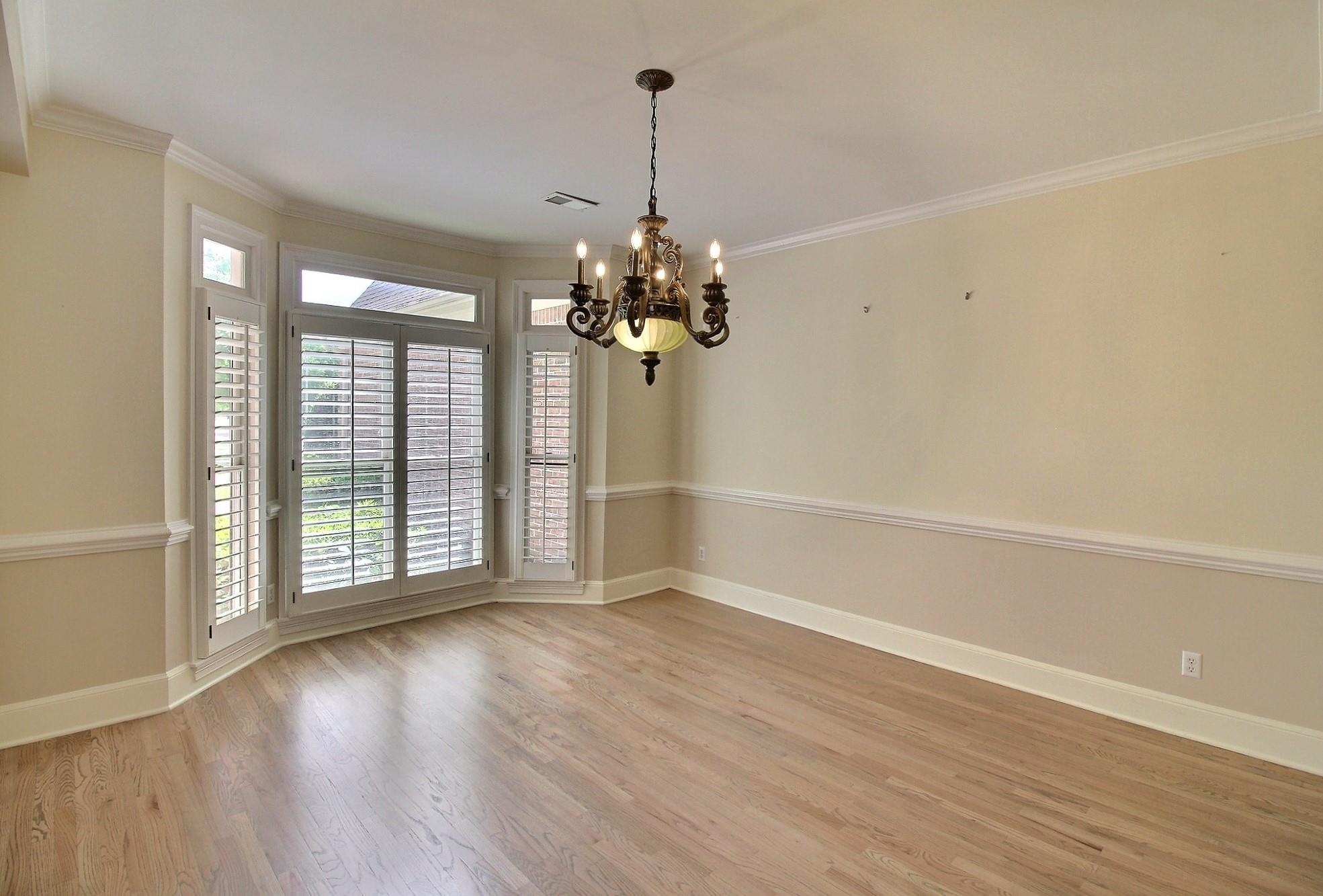 595 Kenrose Street Collierville, TN 38017 - Photo 6 of 38 a view of a room with wooden floor and a chandelier
