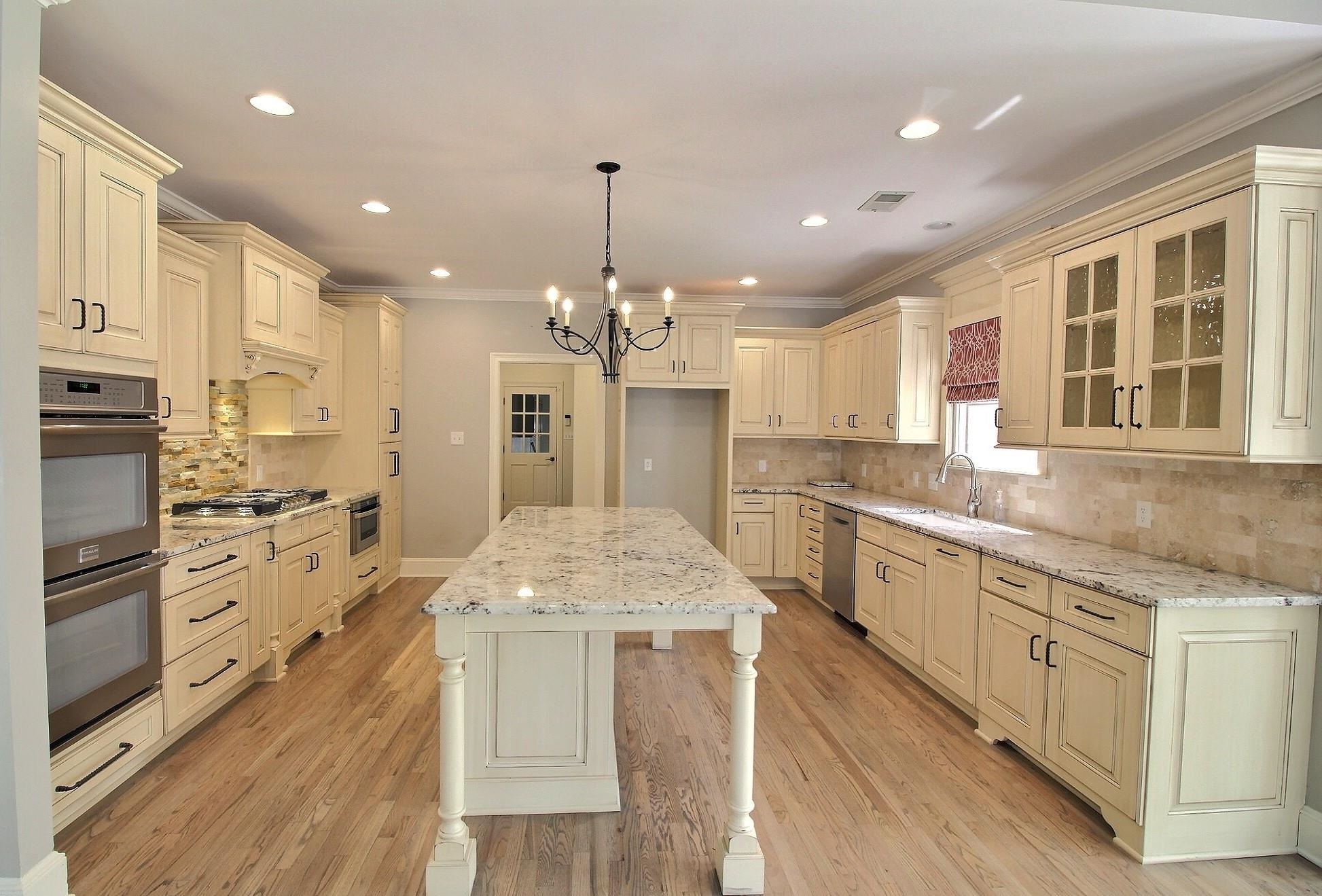 595 Kenrose Street Collierville, TN 38017 - Photo 9 of 38 a large kitchen with granite countertop a large counter top a sink stainless steel appliances and cabinets