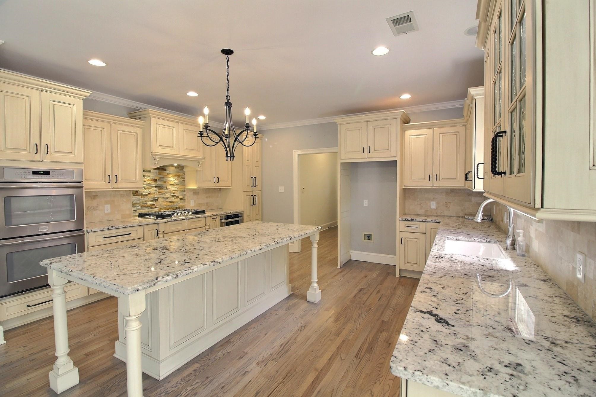 595 Kenrose Street Collierville, TN 38017 - Photo 10 of 38 a large kitchen with kitchen island a large counter top space appliances and cabinets