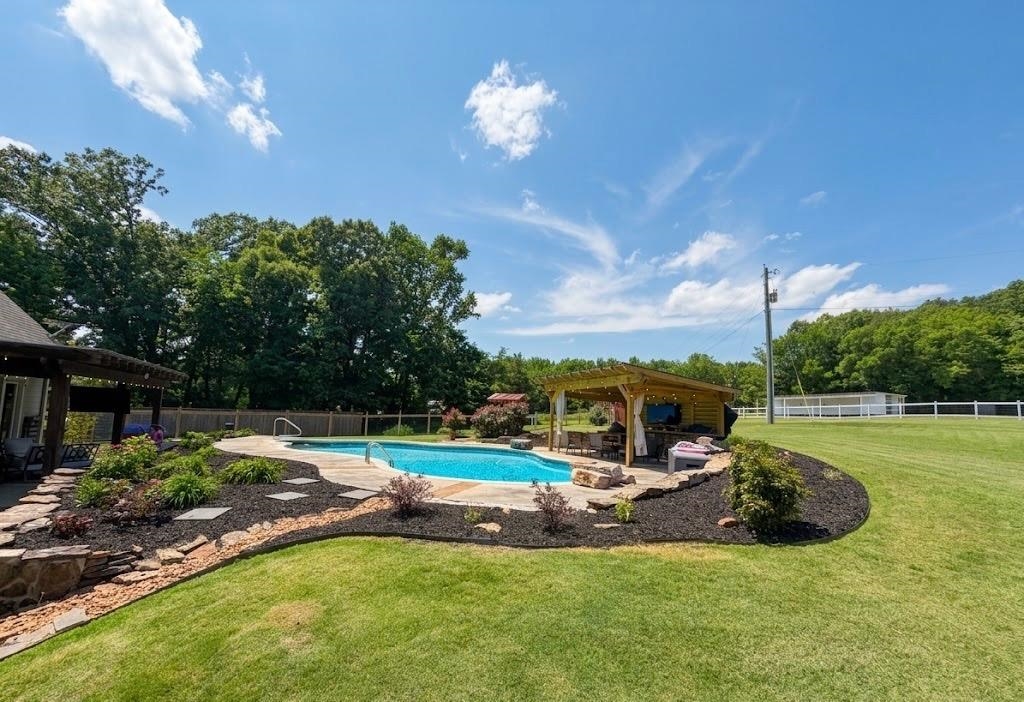 897 Burrowtown Road Mason, TN 38049 - Photo 35 of 40 Freeform swimming pool with stone coping