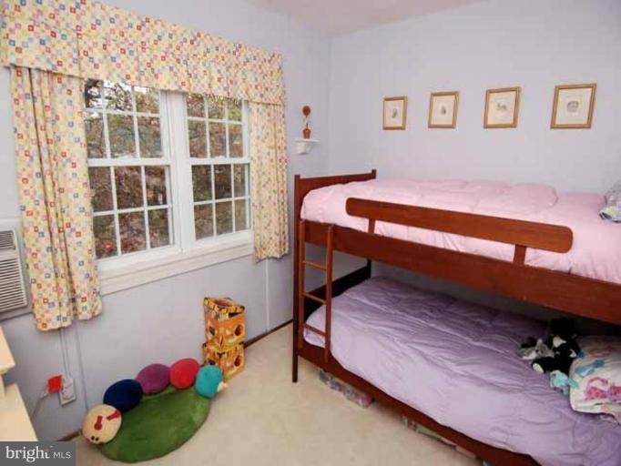 3237 Gunston Road, Unit 104 Alexandria, VA 22302 - Photo 12 of 16 a bedroom with furniture and a window