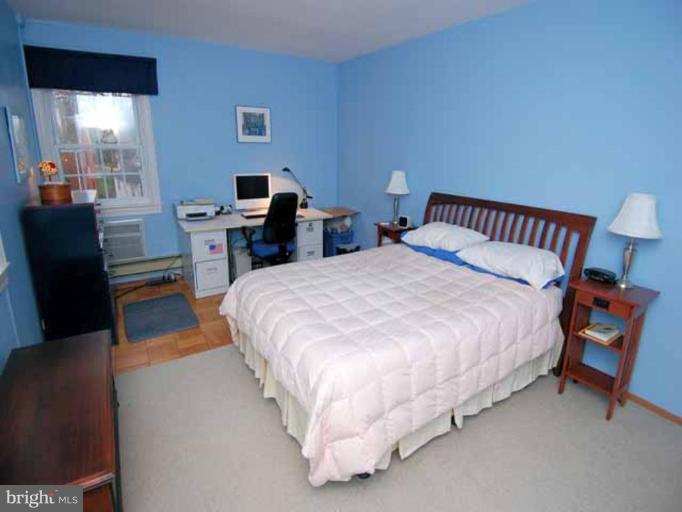 3237 Gunston Road, Unit 104 Alexandria, VA 22302 - Photo 14 of 16 a bed room with a bed and a chair