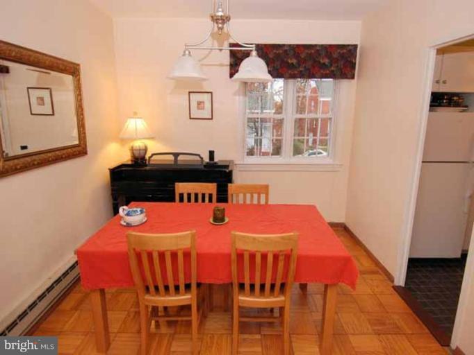 3237 Gunston Road, Unit 104 Alexandria, VA 22302 - Photo 6 of 16 a dining room with a table and chairs