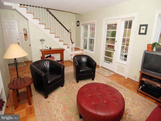 3237 Gunston Road, Unit 104 Alexandria, VA 22302 - Photo 7 of 16 a living room with furniture and a flat screen tv
