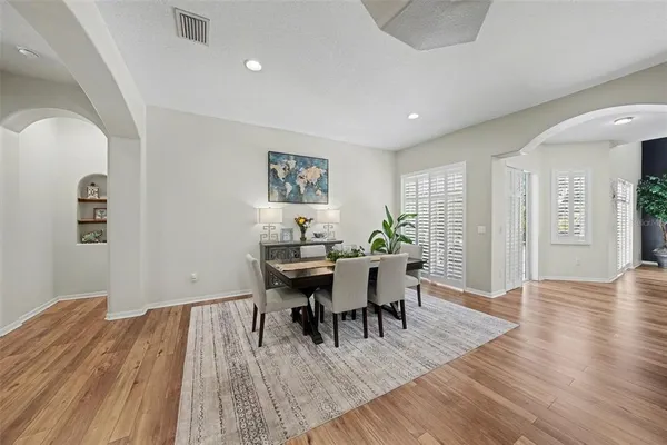 a view of a dining room with furniture and wooden floor