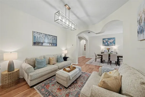 a living room with furniture and a chandelier