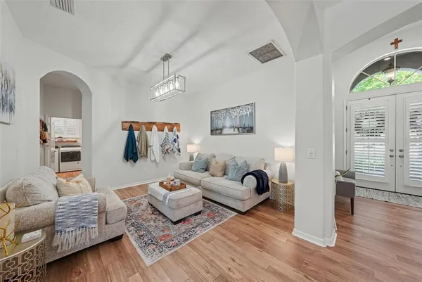 a living room with furniture and a wooden floor