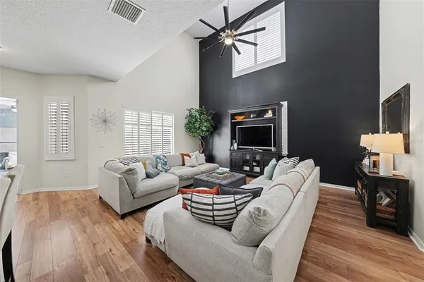 a living room with furniture fireplace and a flat screen tv