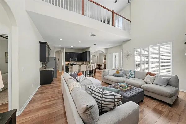 a living room with furniture kitchen and a table