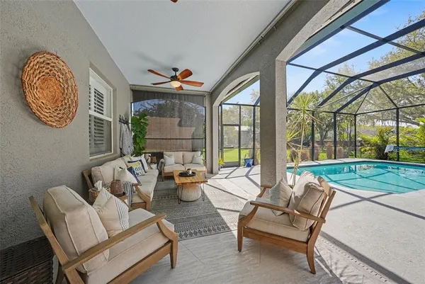 a living room with furniture and a floor to ceiling window