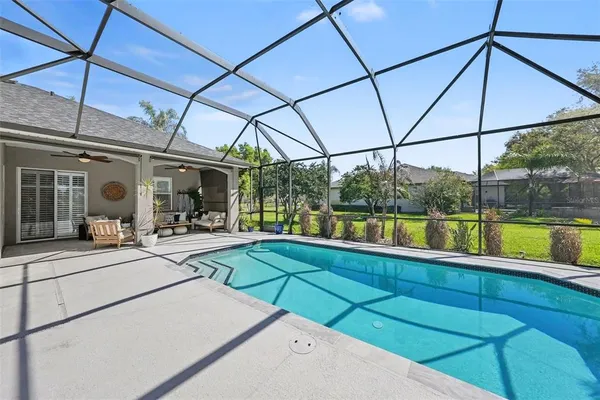 a view of a patio with a table and chairs under an umbrella