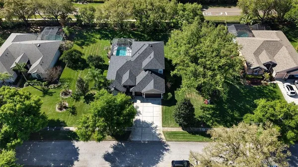 an aerial view of a house with a yard basket ball court and outdoor seating