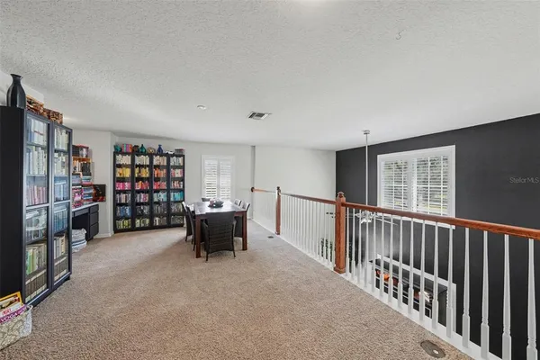 a view of a livingroom with furniture and staircase