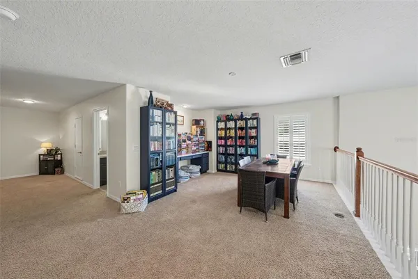 a view of a livingroom with furniture and a window