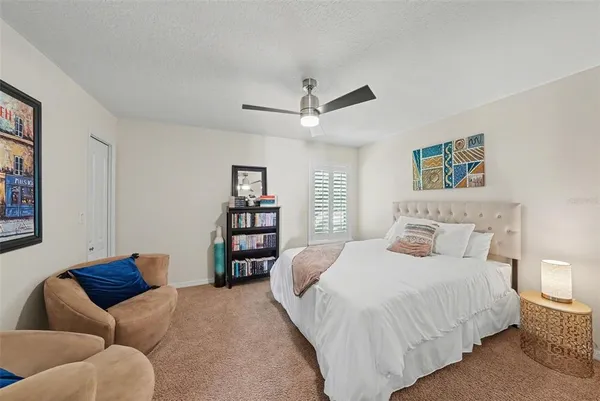 a bedroom with a bed couch and a window