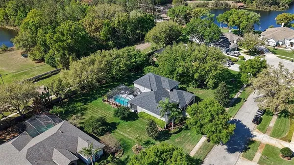 an aerial view of a house with a yard