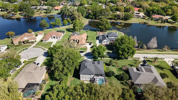 an aerial view of a house with a lake view