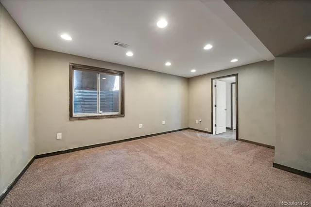 a bathroom with a toilet a sink a mirror and vanity