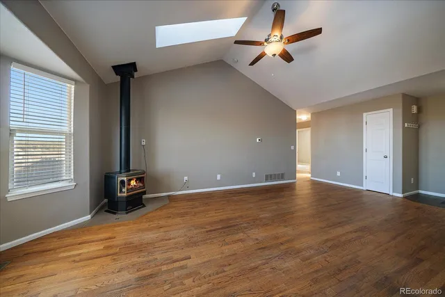 a view of a kitchen with wooden floor and a refrigerator