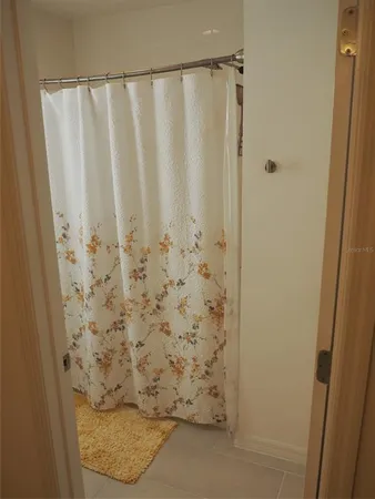 a bathroom with a shower curtain and a sink
