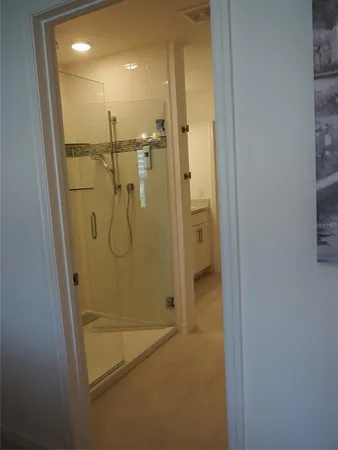 a bathroom with a glass shower door